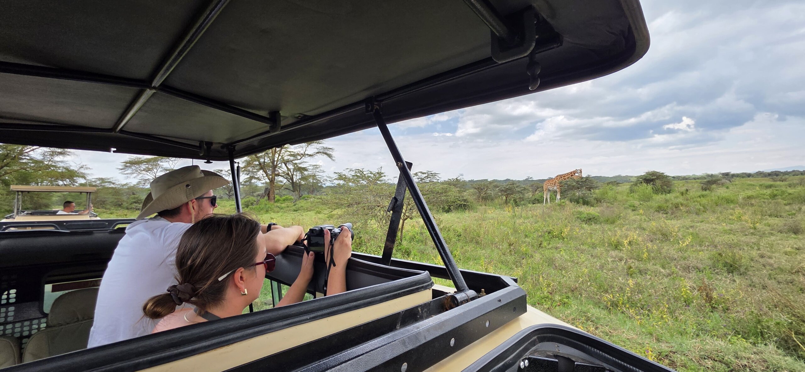 tourist on a Masai Mara safari with cross wild safaris in Kenya photographing Masai Mara