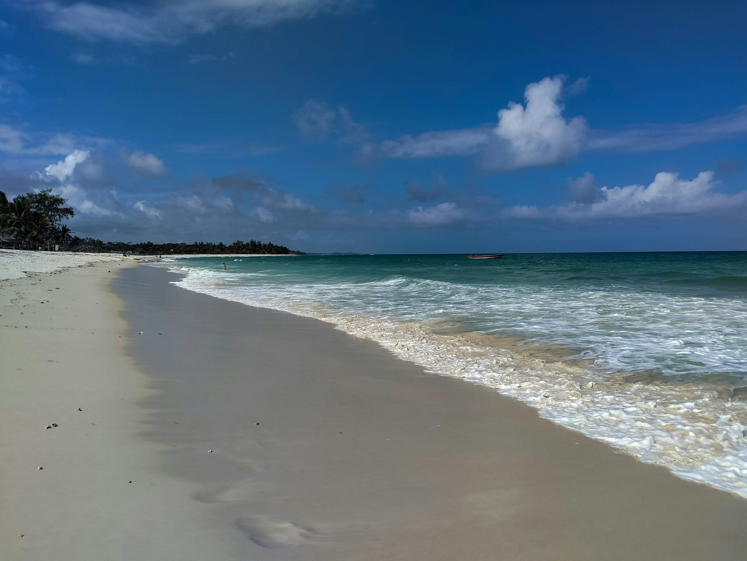 Pristine Diani Beach with palm trees and turquoise waters along Kenya’s coastline