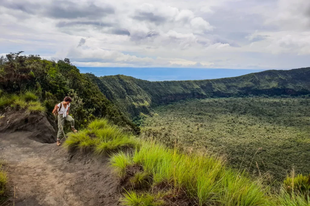 Hikers standing on the crater rim of Mount Longonot with Lake Naivasha in the background