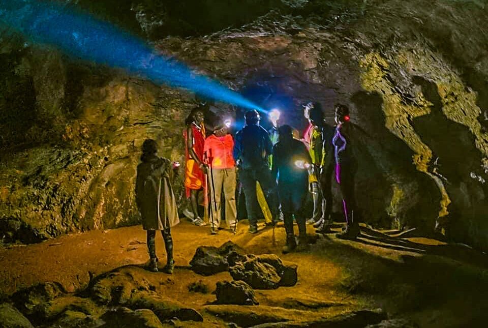 Adventurers exploring Mount Suswa’s underground lava tunnels