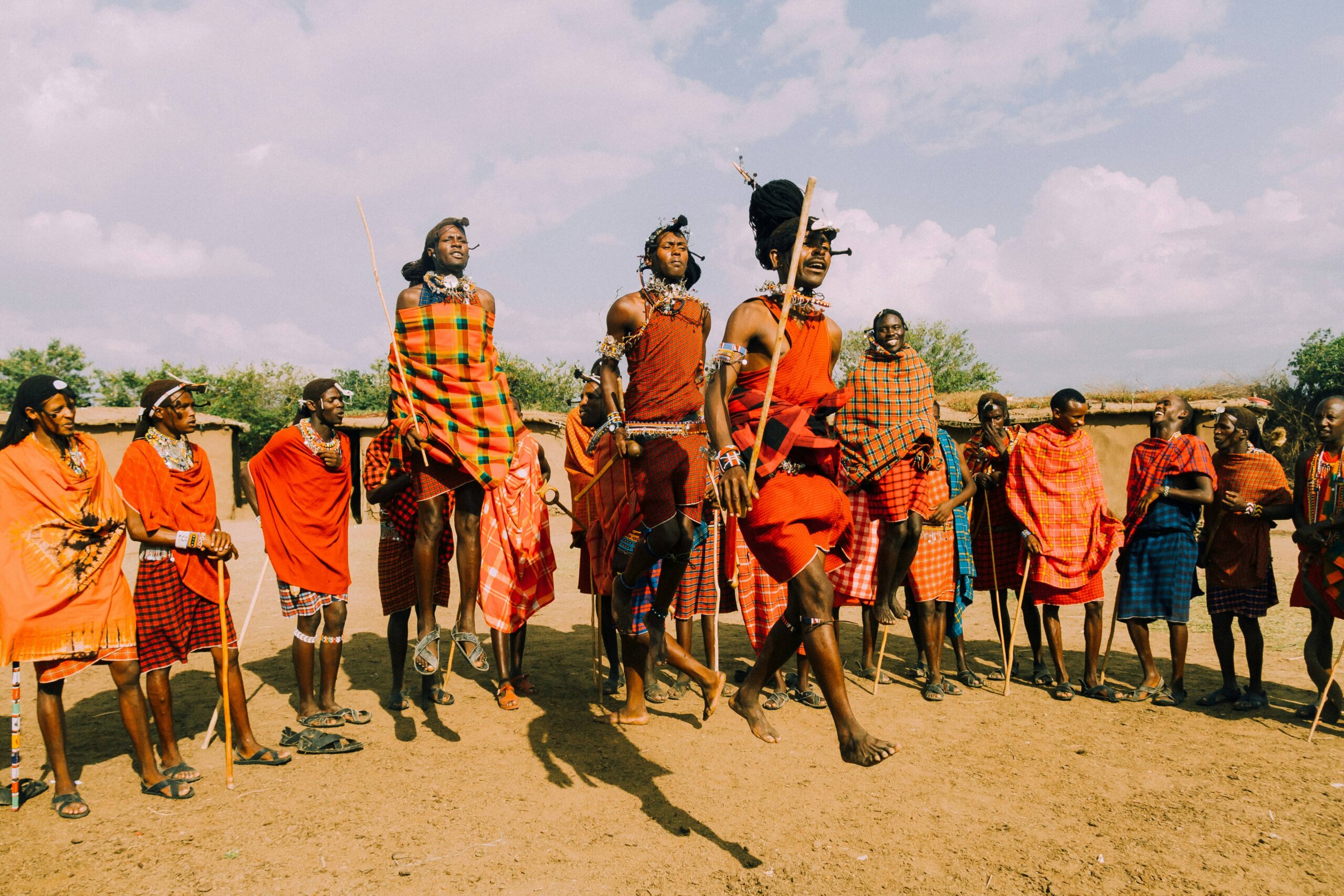 Children joyfully participating in a traditional Maasai jumping dance during a cultural village visit.