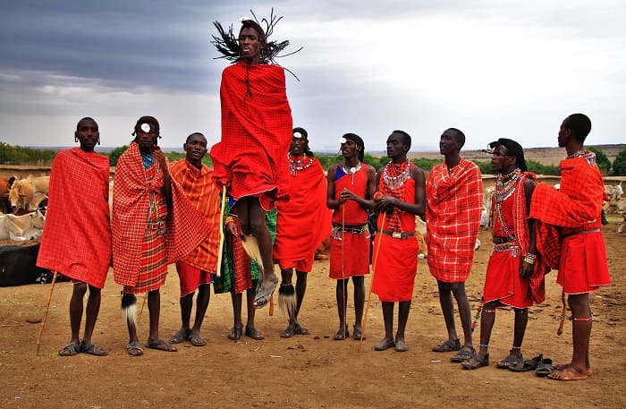 Maasai warriors performing traditional dance during village visit