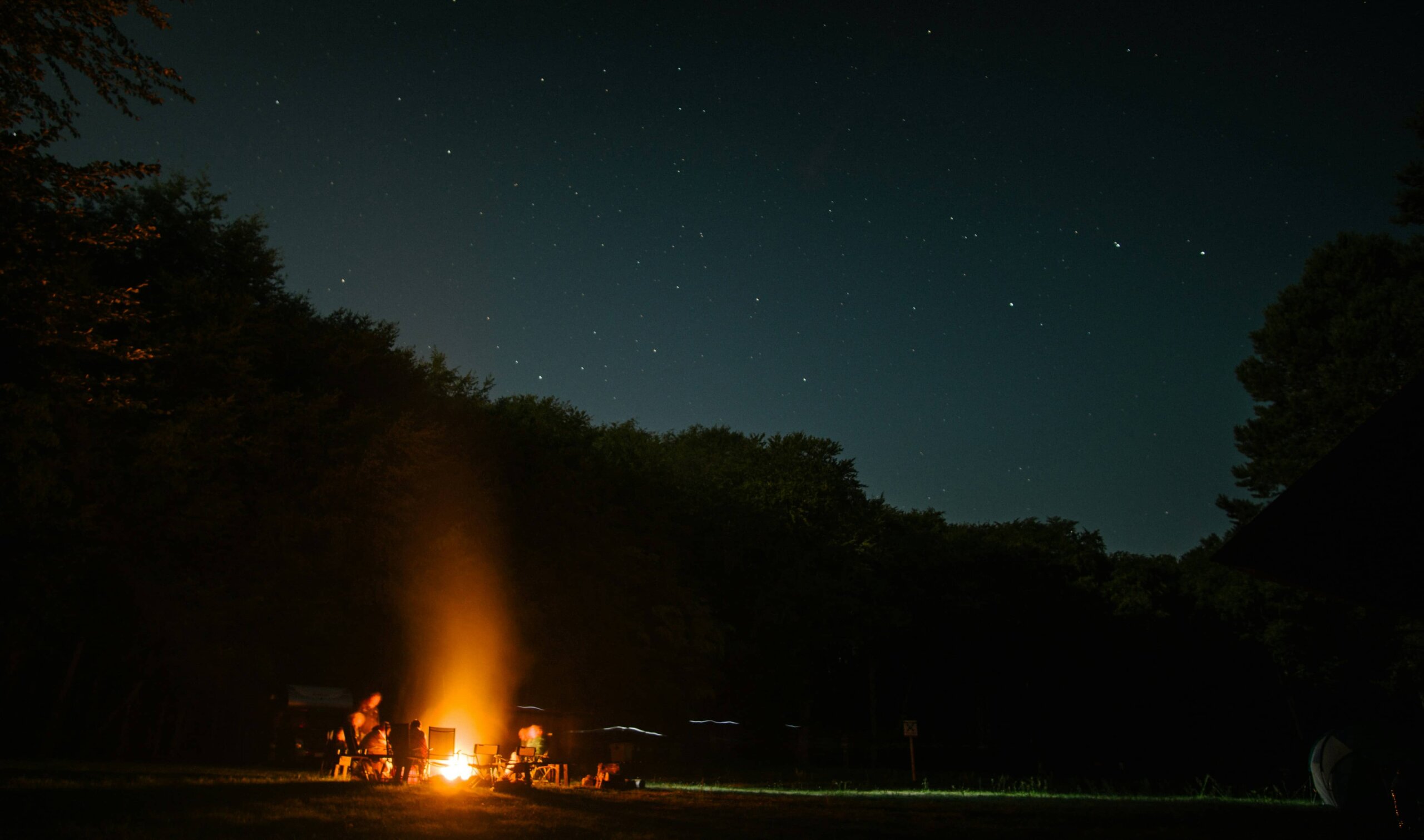 Family stargazing at the clear Milky Way night sky from a Kenyan safari camp during a kids safari