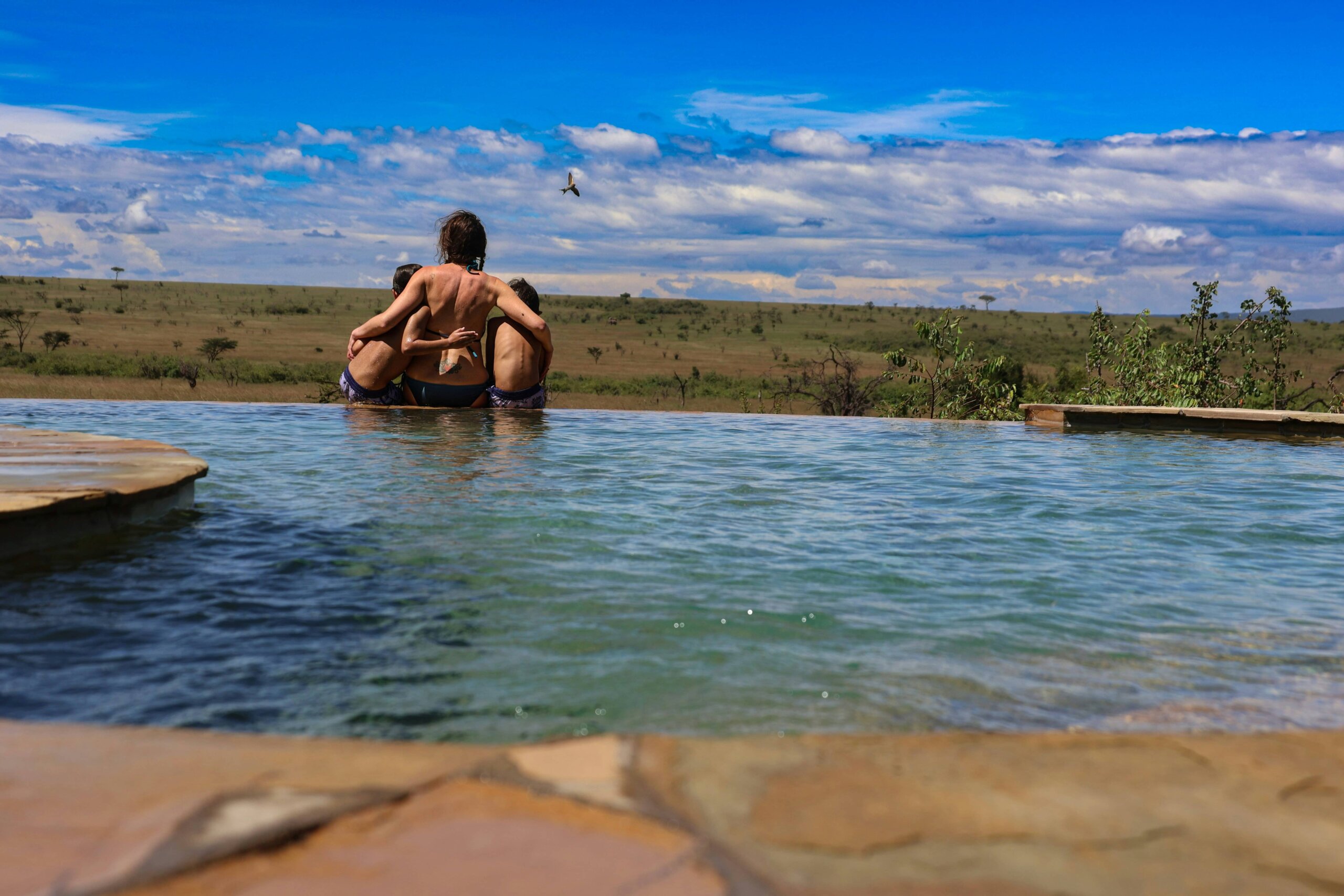 Kids enjoying a swim on a family friendly safari in Masai mara, Kenya