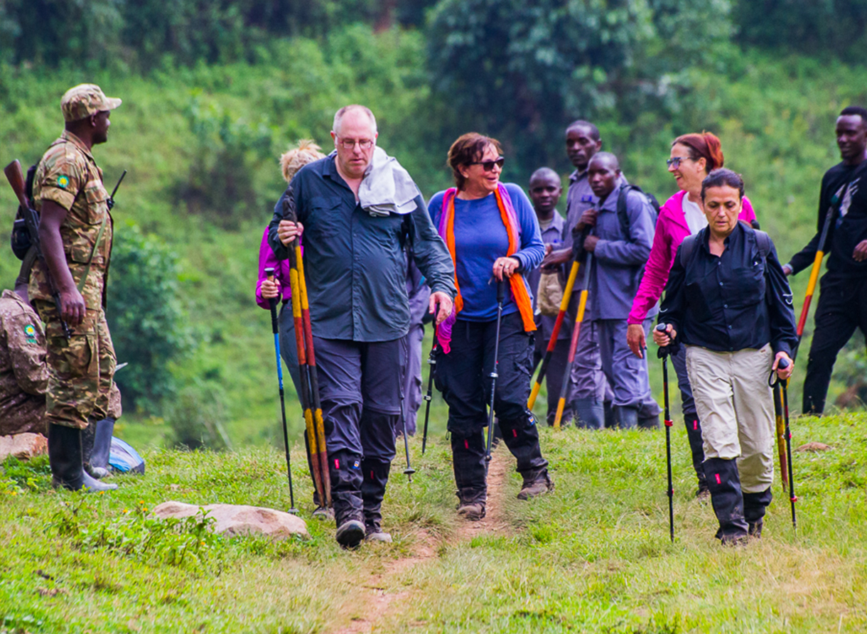Safari traveler wearing quick-dry clothing in lush green savannah after rainy season in Kenya.
