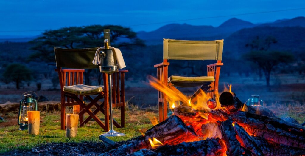 Luxury bush dinner setup in Kenyan safari lodge