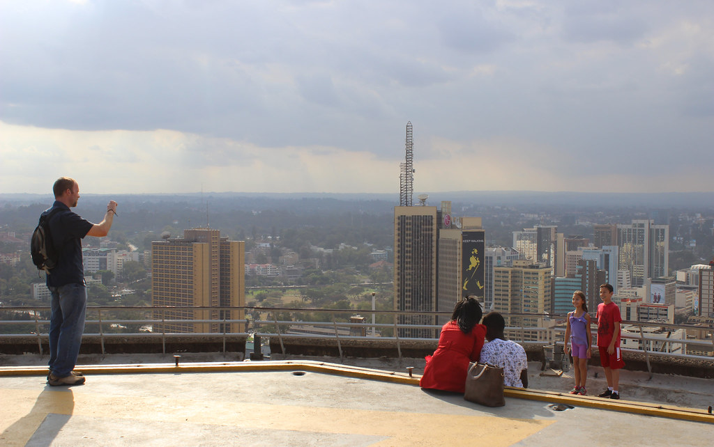 Tourists taking photos on top of KICC with Nairobi city views