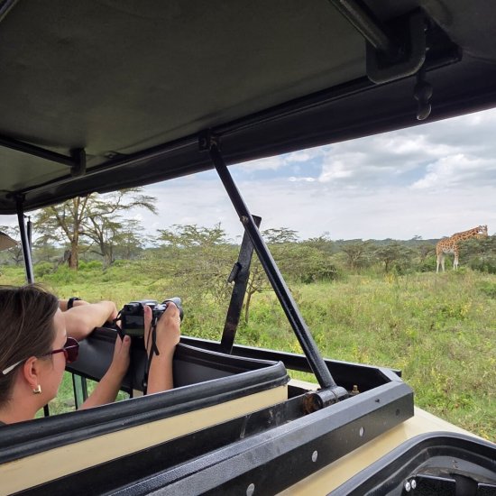 tourist on a Masai Mara safari with cross wild safaris in Kenya photographing Masai Mara