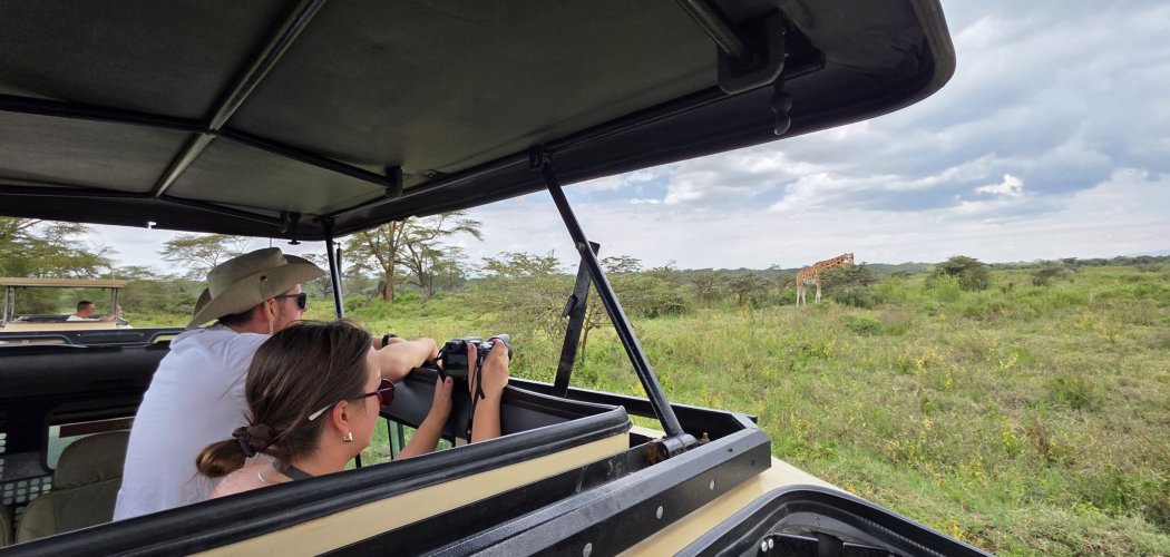 tourist on a Masai Mara safari with cross wild safaris in Kenya photographing Masai Mara