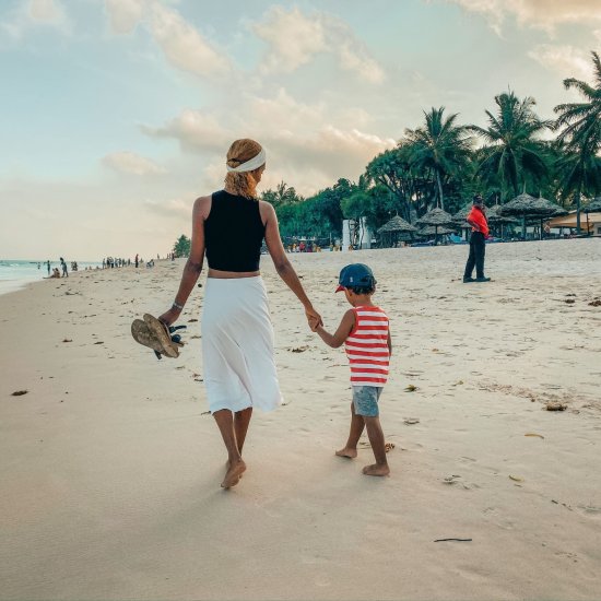 Family enjoying a day at Diani Beach, activities in Mombasa with children building sandcastles